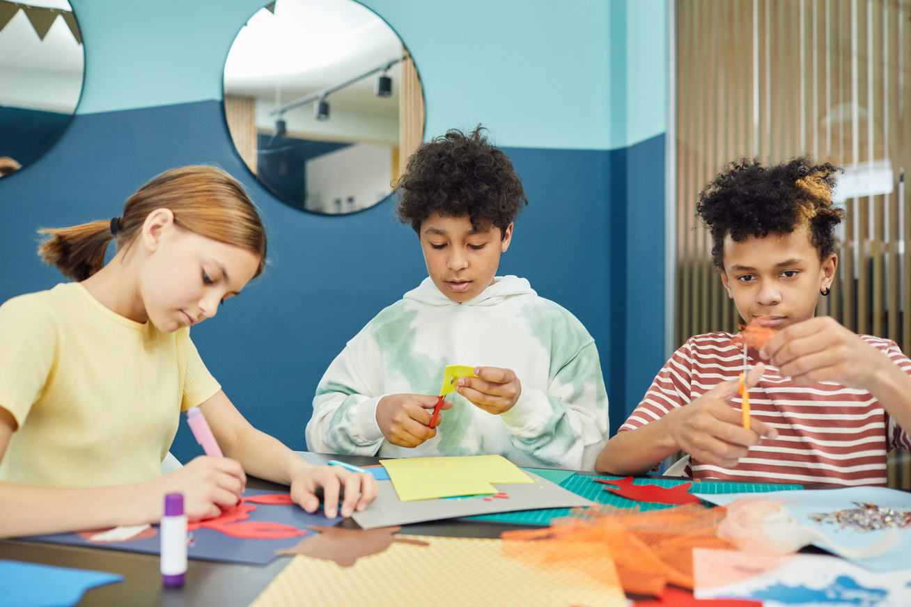 Multiethnic kids making drawings in art school